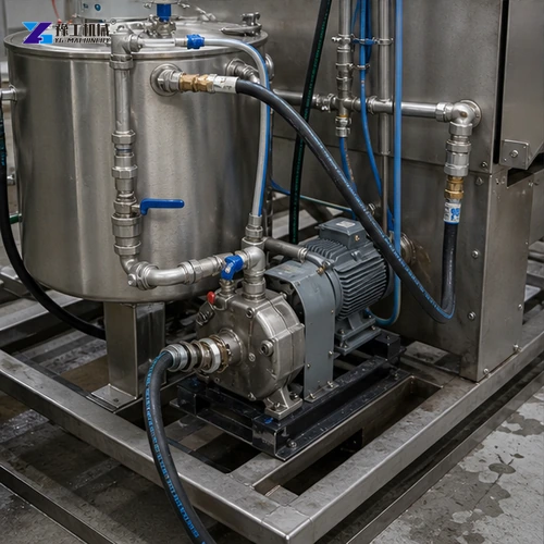 Slurry tank pump and circulation lines beside blasting cabinet