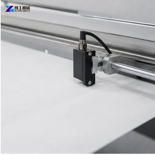 Optical edge guide aligning white nonwoven web