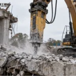 Demolition Attachments For Excavators Selection Guide Excavator fitted with a demolition attachment at a controlled work site