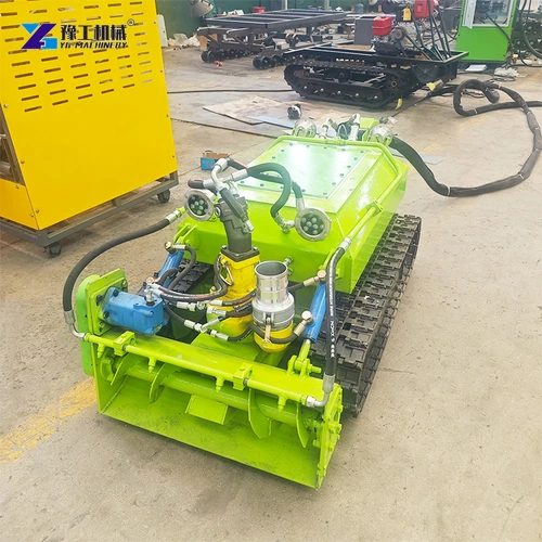 Green tracked sludge dredger with hoses on a factory floor
