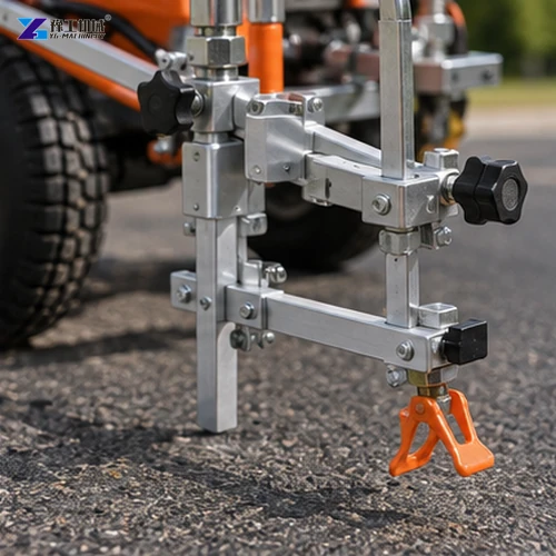 Adjustable metal road marking shoe and nozzle assembly beside asphalt