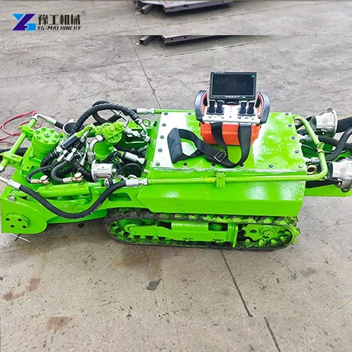Green tracked unit with hydraulic hoses and a portable controller on its body