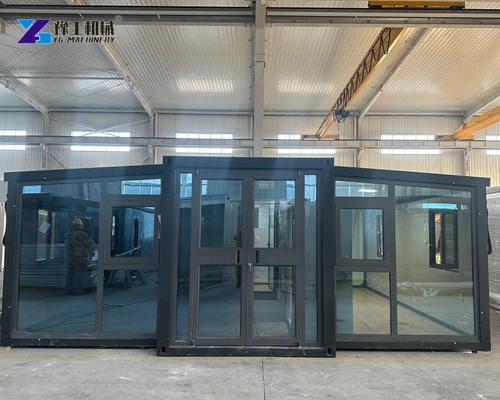 Front and side of an unfolded expandable unit supported inside a workshop