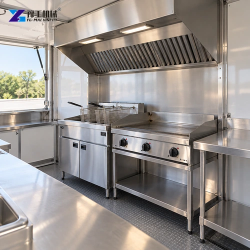 Fryer and griddle arranged beneath a trailer kitchen extraction hood