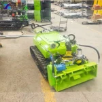 Green tracked sediment-removal unit with its front head and hose connections