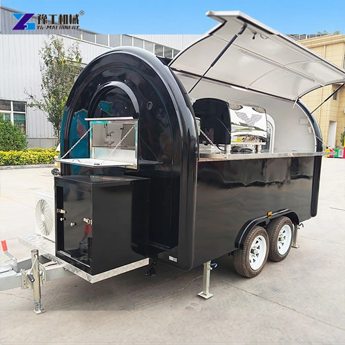Rounded black catering trailer with a raised service hatch and twin axles