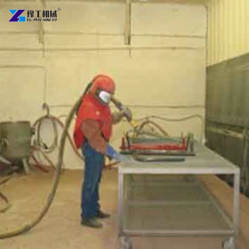 Supported steel workpiece in blast room